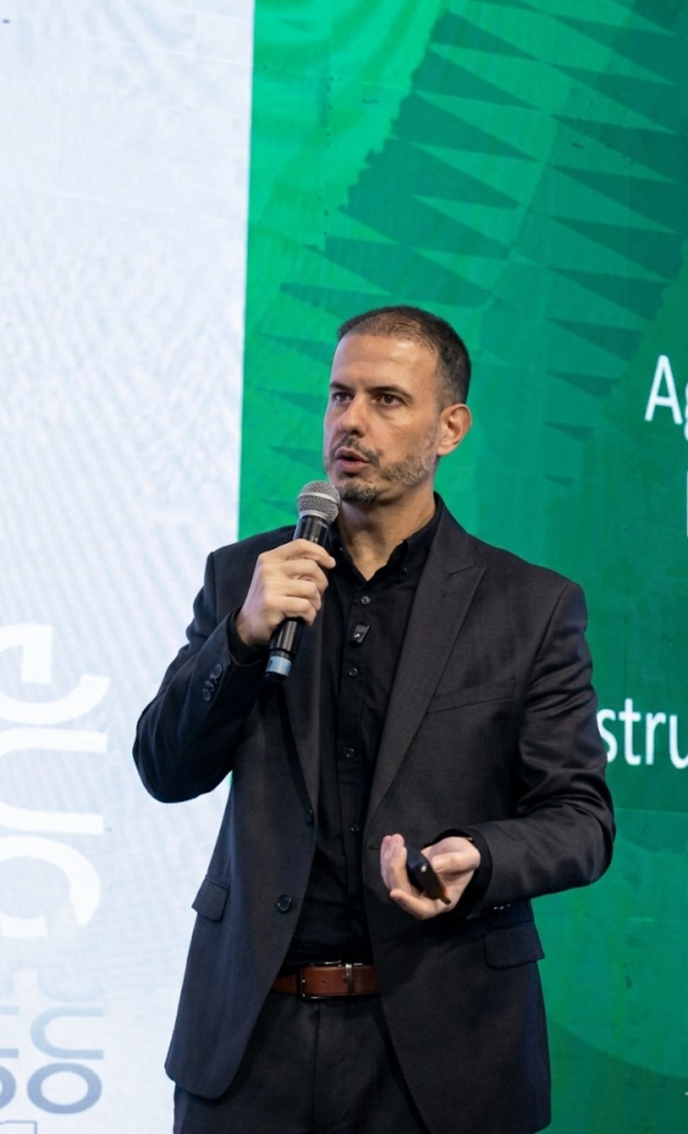 Fábio Barboni em apresentação com cenário verde e enquadramento limpo